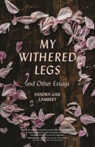 Book cover: lavender flower petals scattered over a brown tree trunk. Text: My Withered Legs and Other Essays Sandra Gail Lambert